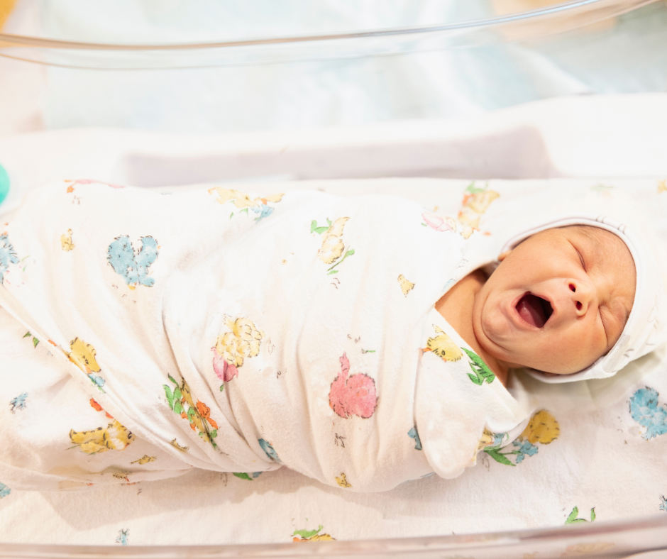 newborn wrapped in hospital blanket